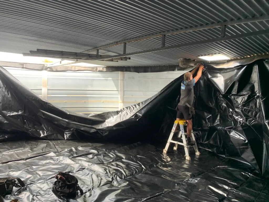New liner being fitted inside a water tank